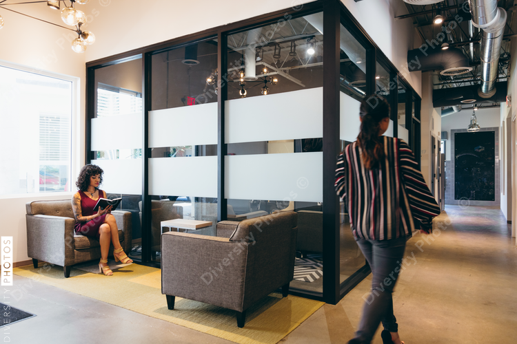 Direct view of woman sitting in lobby with diary 