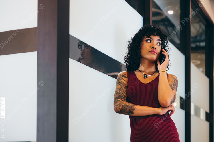 Low angle view of young businesswoman talking over the phone