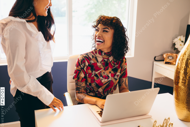 Close up view of young businesswomen talking and laughing