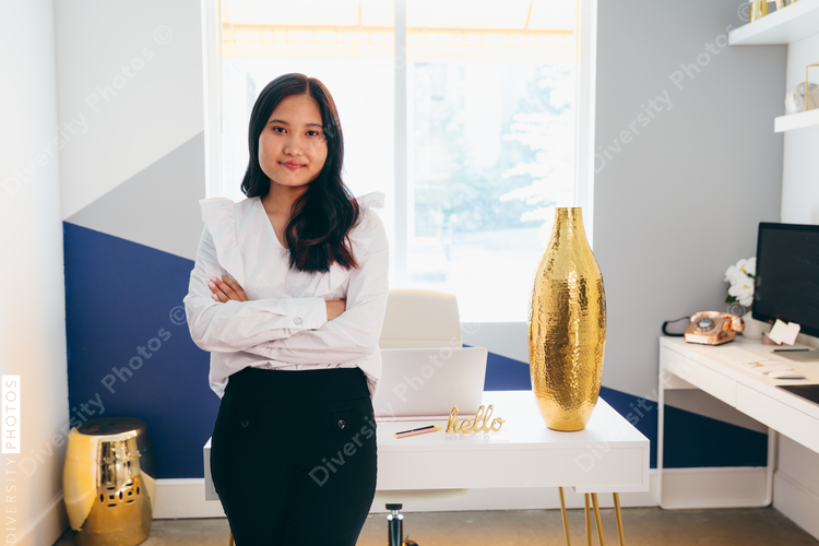 Direct view of businesswoman standing with crossed arms