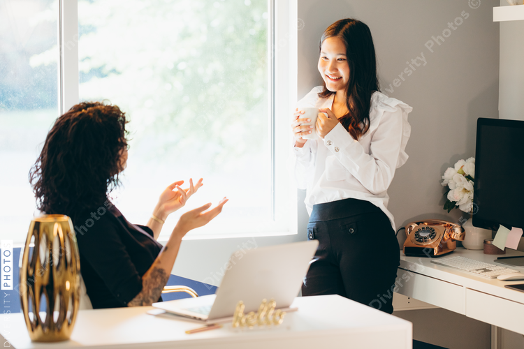 Close up view of two businesswomen talking in office