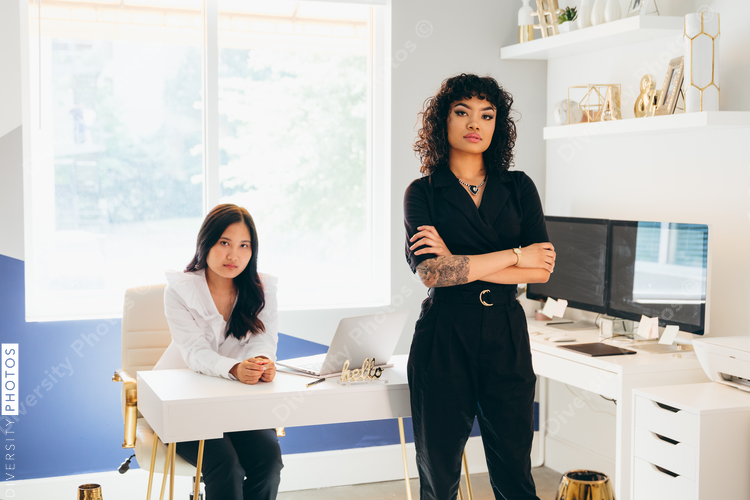Direct view of two businesswomen posing in modern office space