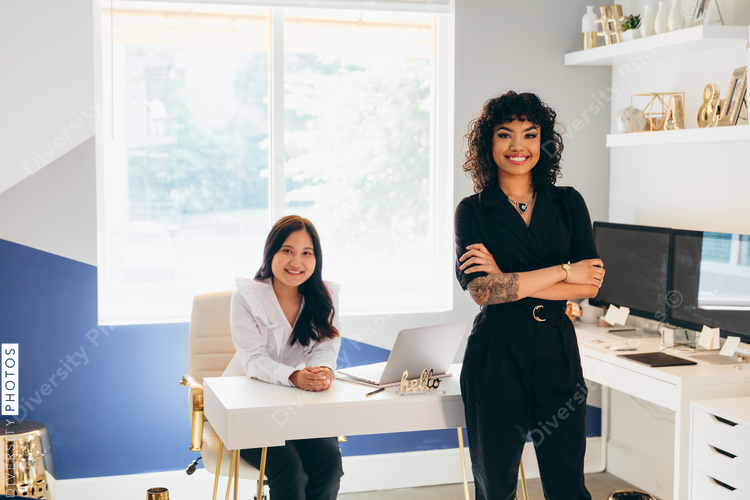 Direct view of two businesswomen posing with a smile