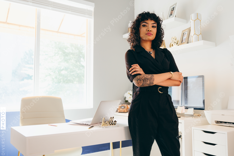Low angle view of young businesswoman standing with crossed arms