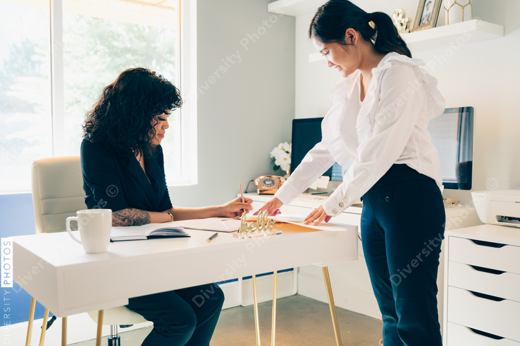 Direct view of two young businesswomen in modern office space