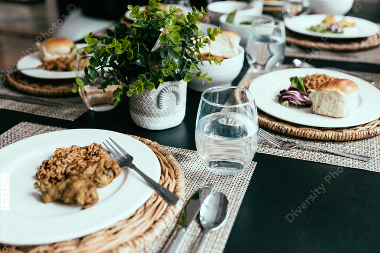 Dinner table setting with Caribbean food