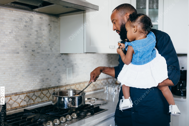 Father preparing food with daughter