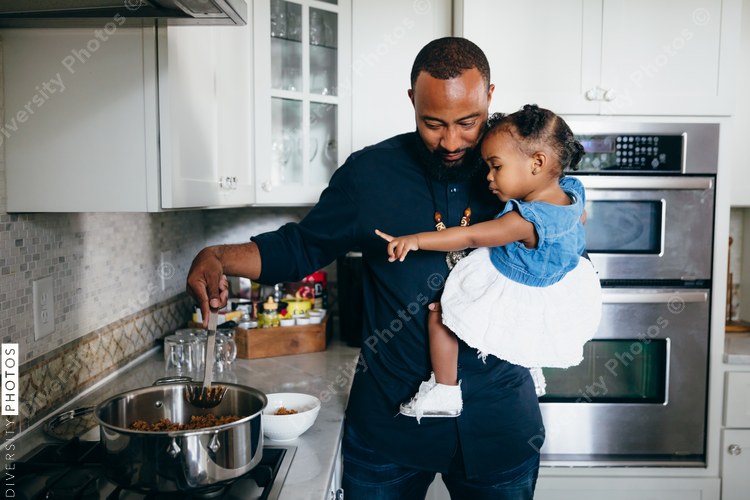 Father preparing food with daughter