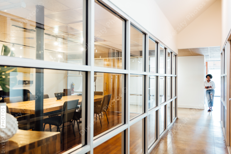 Woman standing in hallway at office