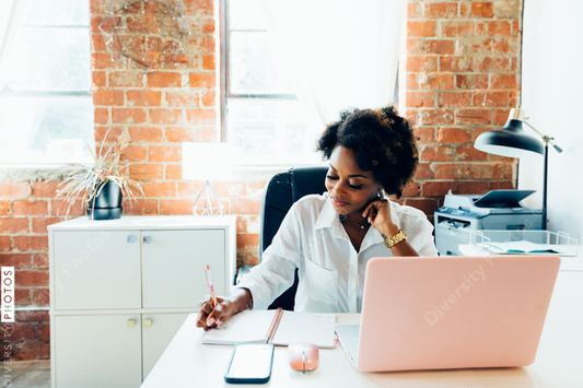 Woman writing notes in office