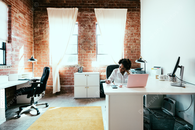 Woman in office writing notes