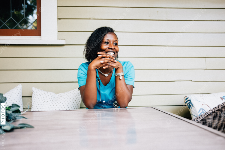 Healthcare professional  sitting outdoors and smiling