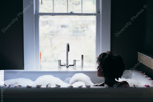 Back view of woman in bathtub