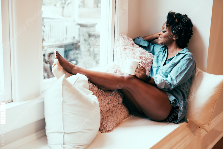 Woman relaxing on windowsill