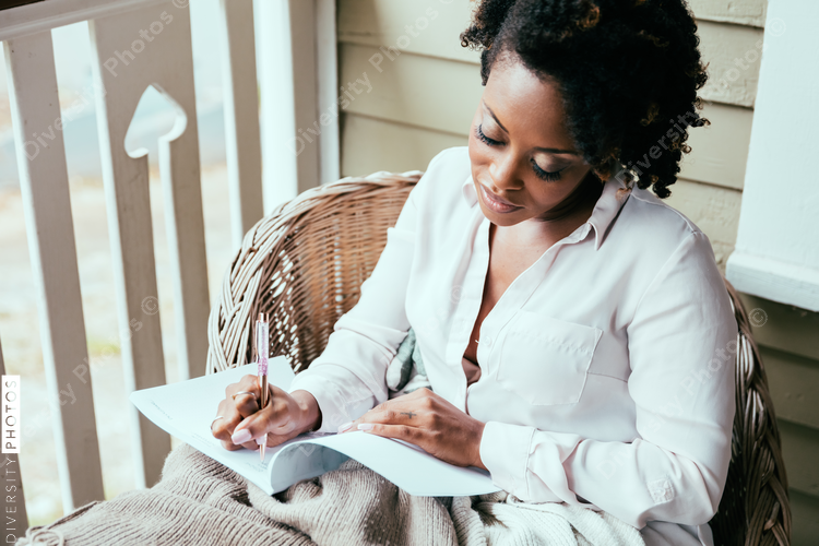 Close up view of woman writing notes