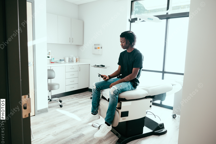 Teenage boy waits to be seen by doctor
