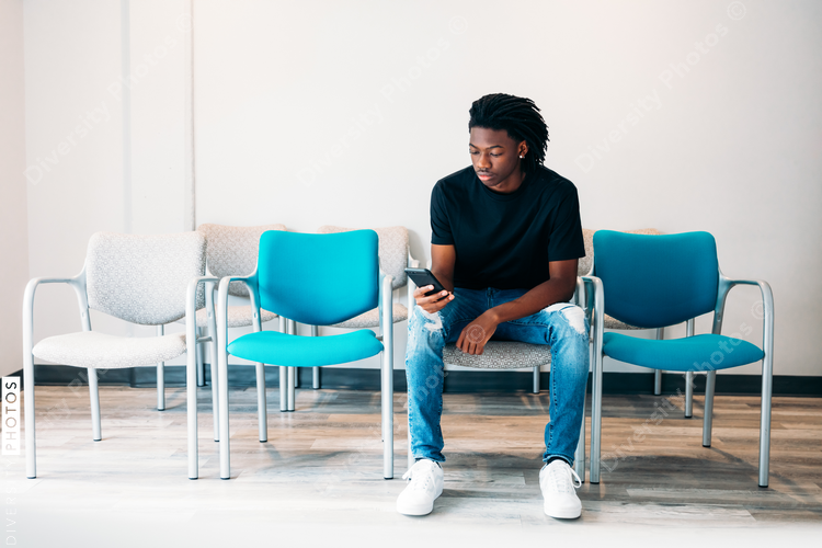 Gen Z boy sitting in doctors wait area
