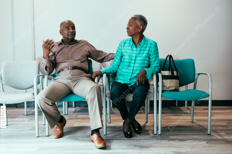 Mature couple waiting in medical office