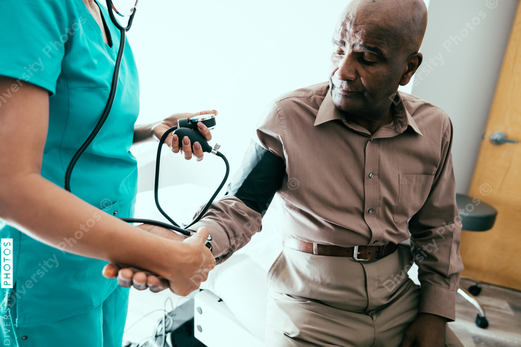 Nurse taking male patient's blood pressure