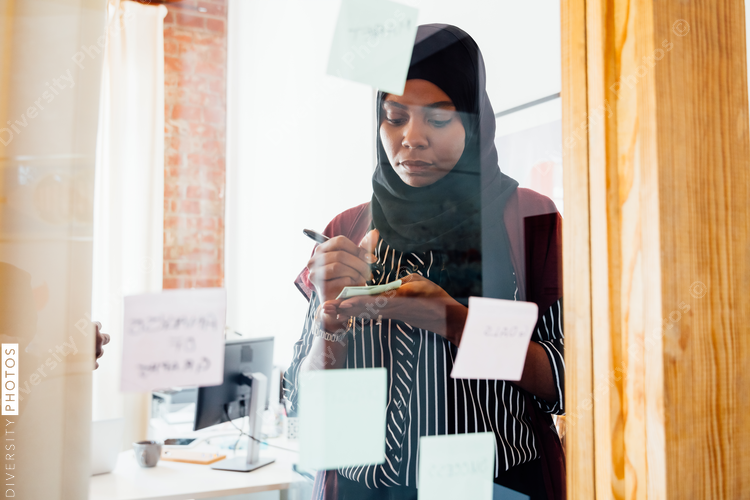 Woman brainstorming and taking notes