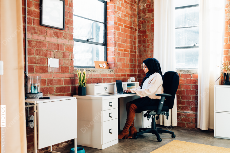 Young Muslim woman working In modern office