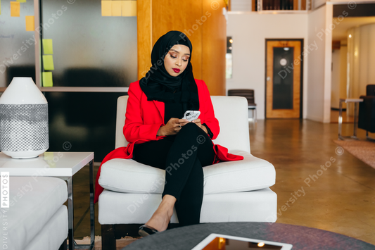 Young Muslim woman on smartphone