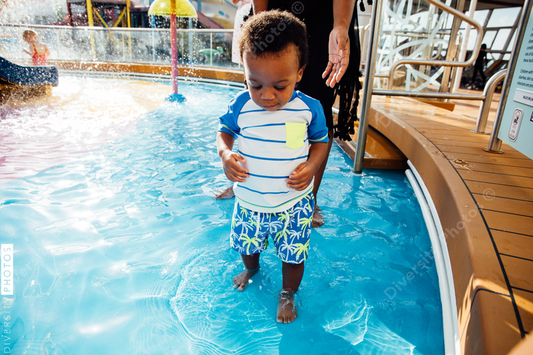 Young toddler playing in pool