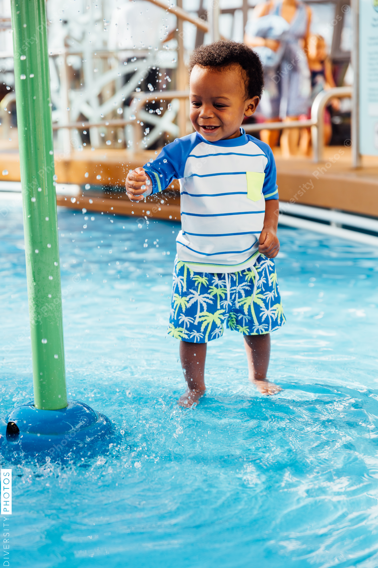Young toddler playing in pool
