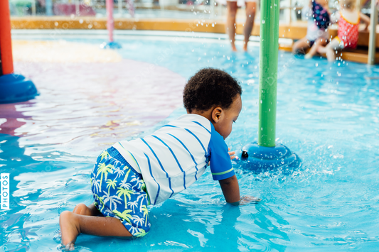 Young toddler playing in pool