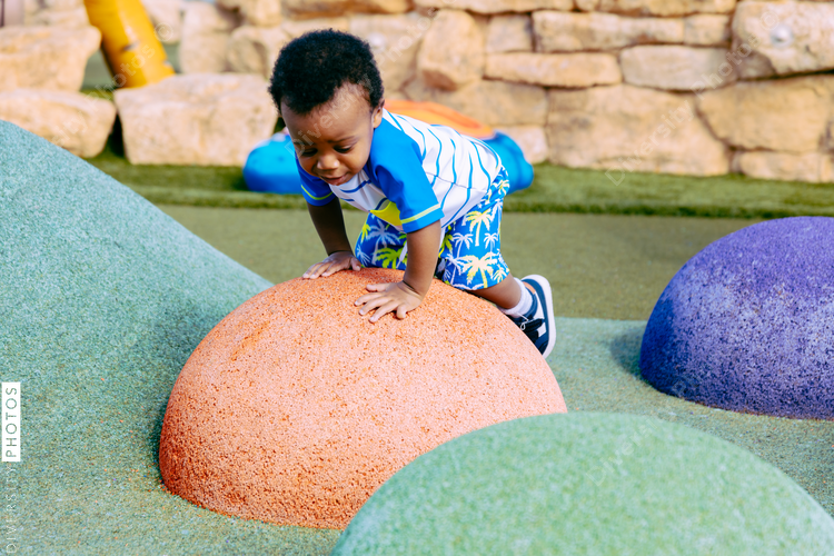 Young boy plays in park