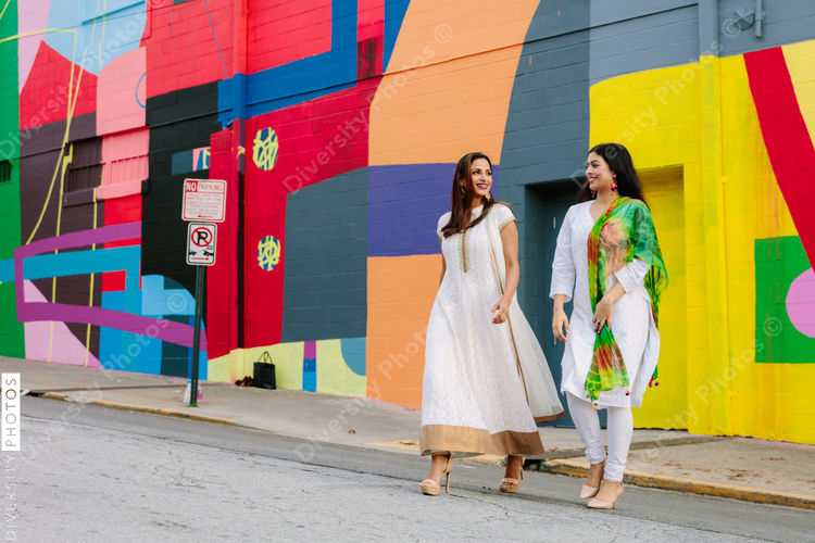 Friends walking and talking along street