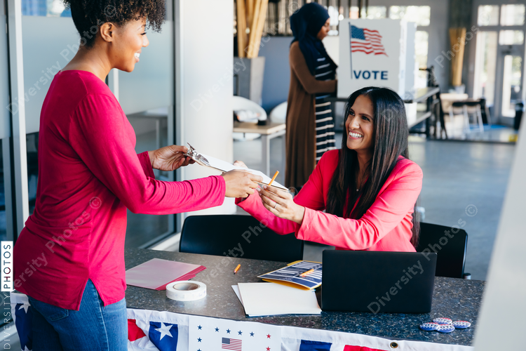 Volunteer helping citizen at polling place