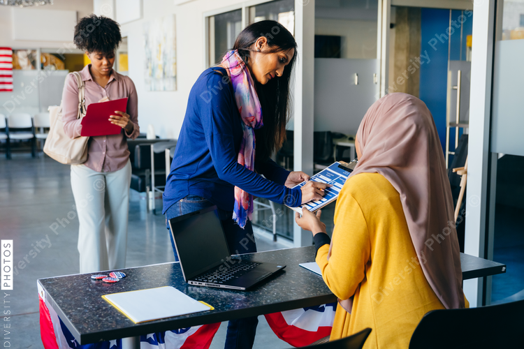 Volunteer helping citizen at polling place
