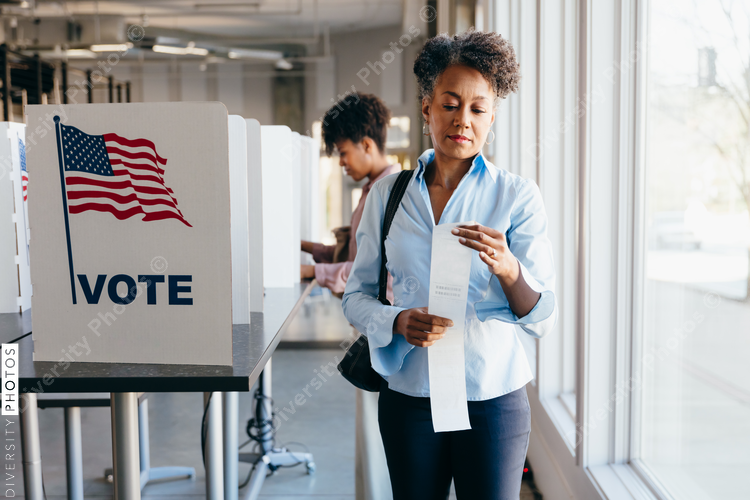 Woman checking paper ballot voting receipt
