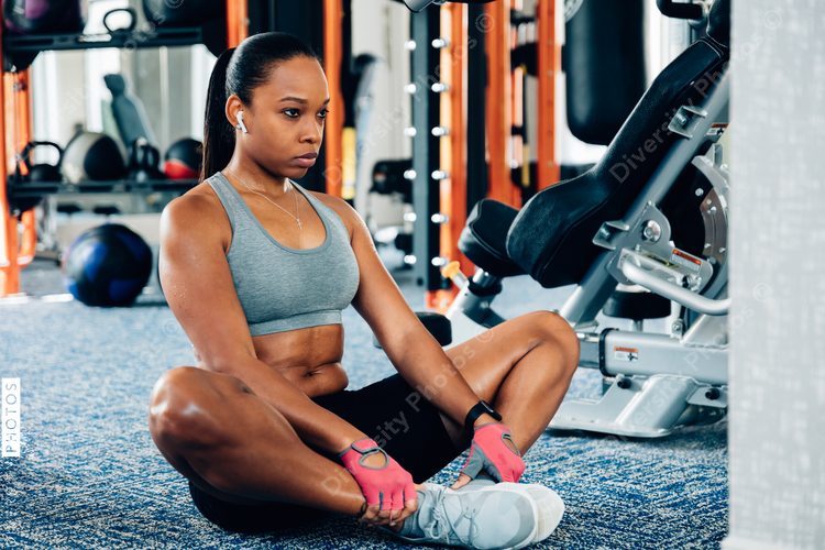 Woman stretching legs in gym