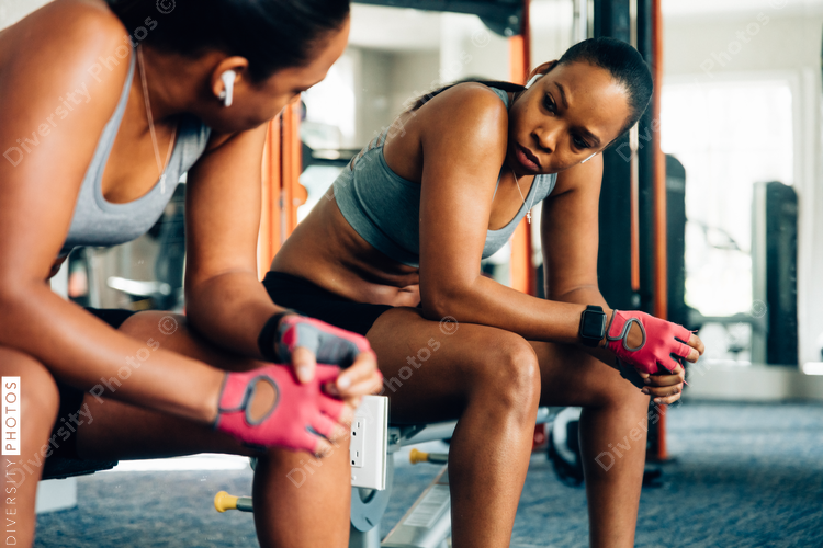 Woman taking a moment to rest in gym