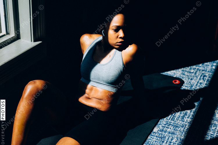 Woman taking a moment to rest in gym