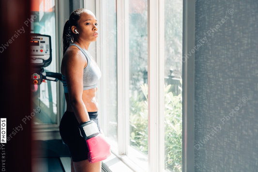 Young woman wearing boxing gloves