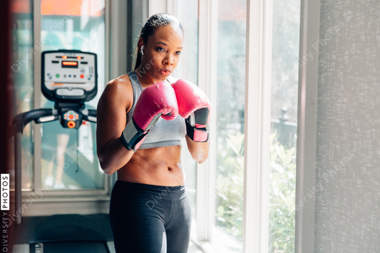 Young woman wearing boxing gloves