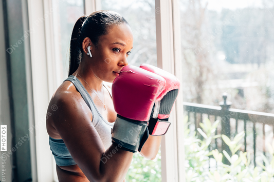 Young woman wearing boxing gloves