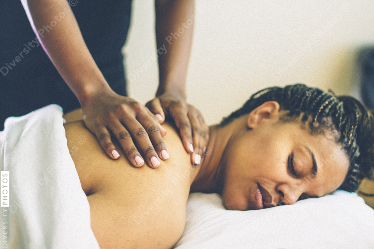 Woman receiving back massage at spa