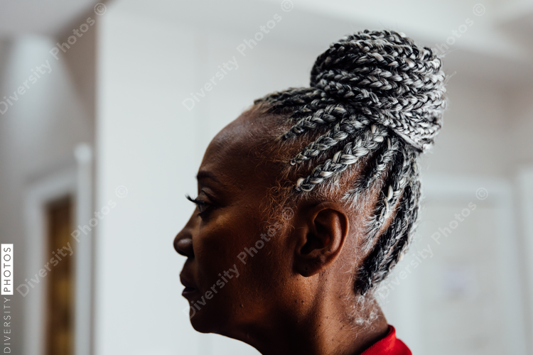 Profile of Senior Black woman with grey hair and braids