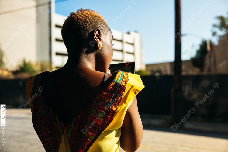 African woman crossing street in the city