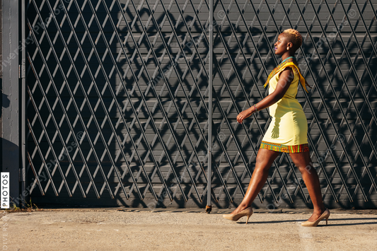 Young fashionable woman walking city street