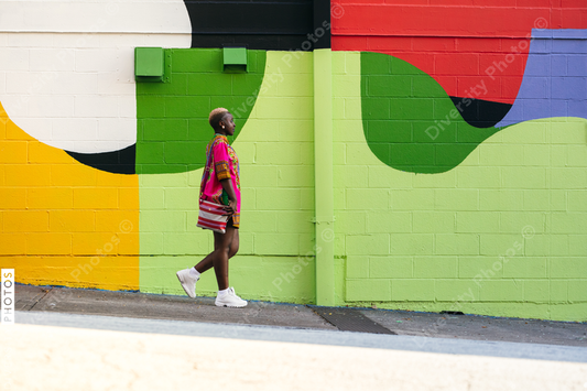 Young fashionable woman walking city street