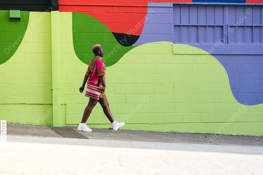 Young fashionable woman walking city street