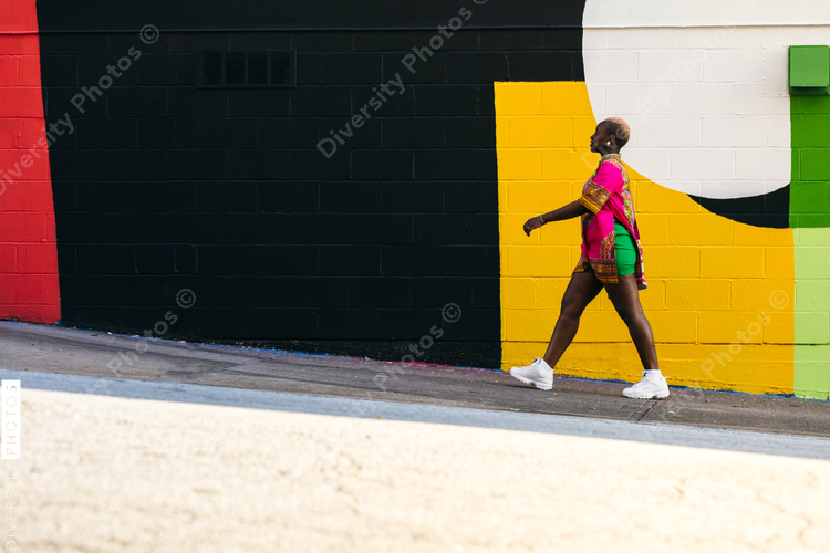 Young fashionable woman walking city street