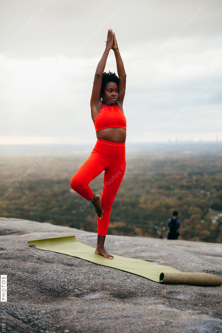 Black woman doing yoga at park