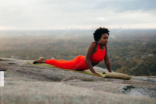 Black woman doing yoga at park
