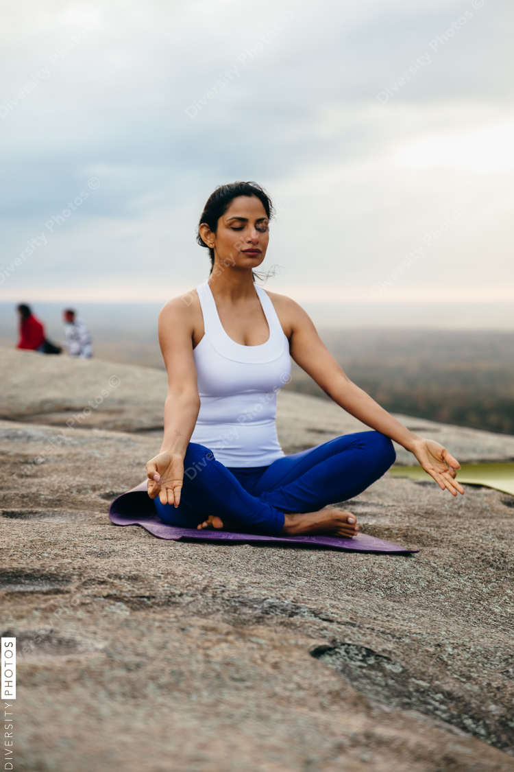 Indian woman breathing and doing meditation at park